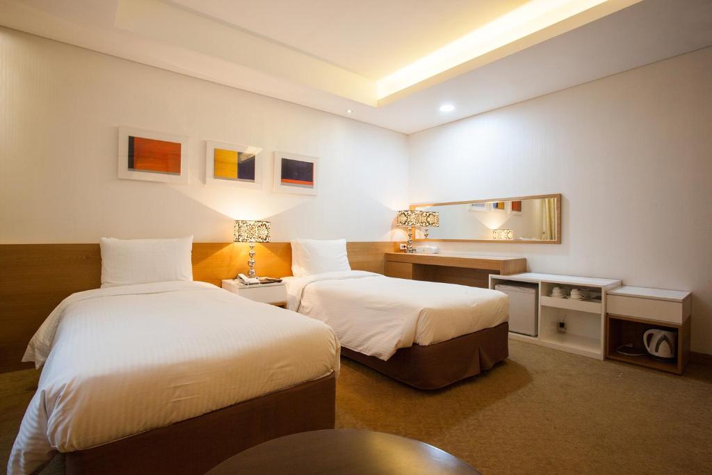 Postel nebo postele na pokoji v ubytování Hotel Pharos