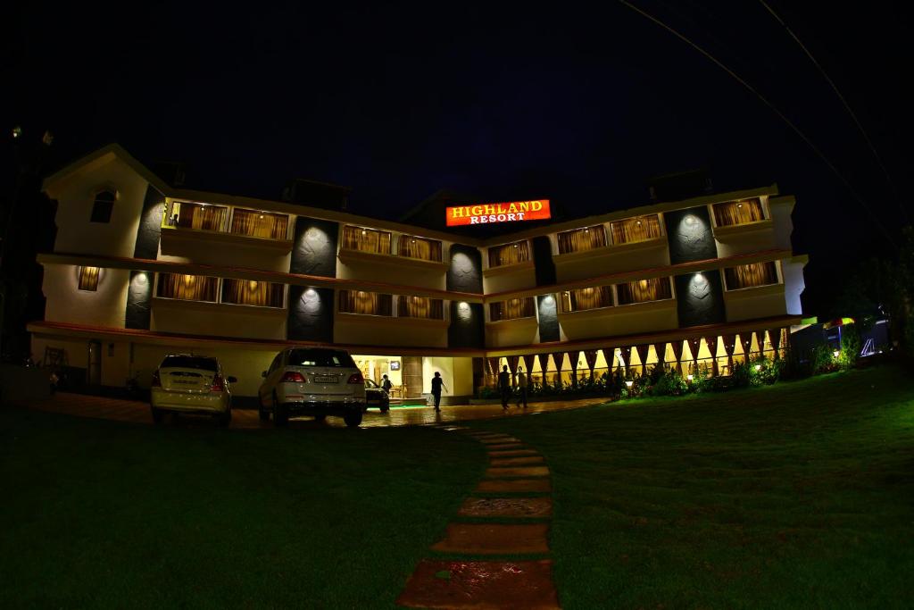 ein Gebäude mit nachts vor ihm geparkt in der Unterkunft Highland Resort in Lonavla