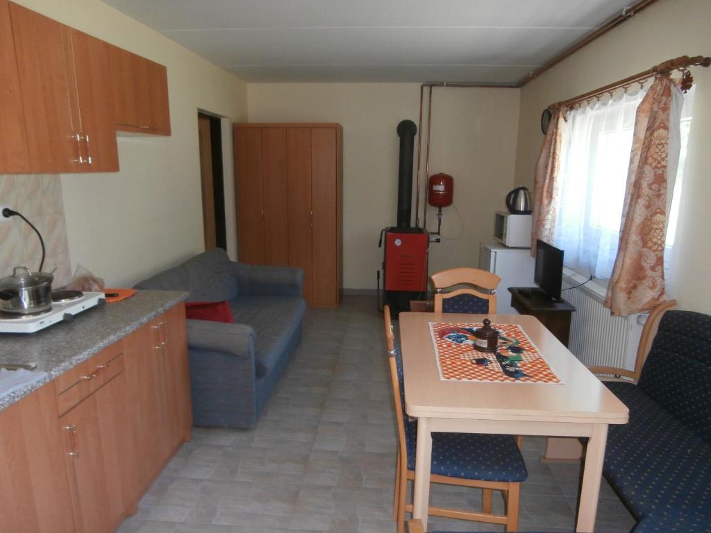 a kitchen and a living room with a table and chairs at Vila Jaro in Chocerady