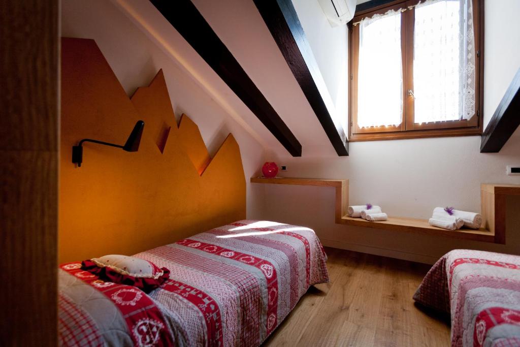Postel nebo postele na pokoji v ubytování Grand Hotel Gortani