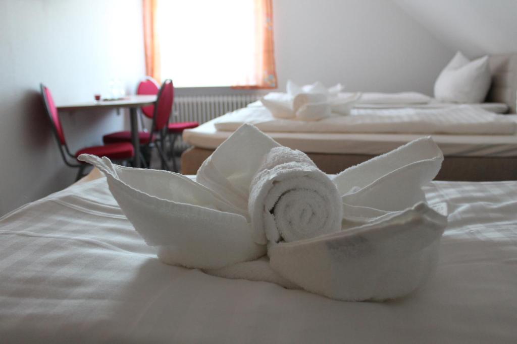 a white towel on top of a bed at Gästehaus Hubertushof - 24h Check-In in Hausen