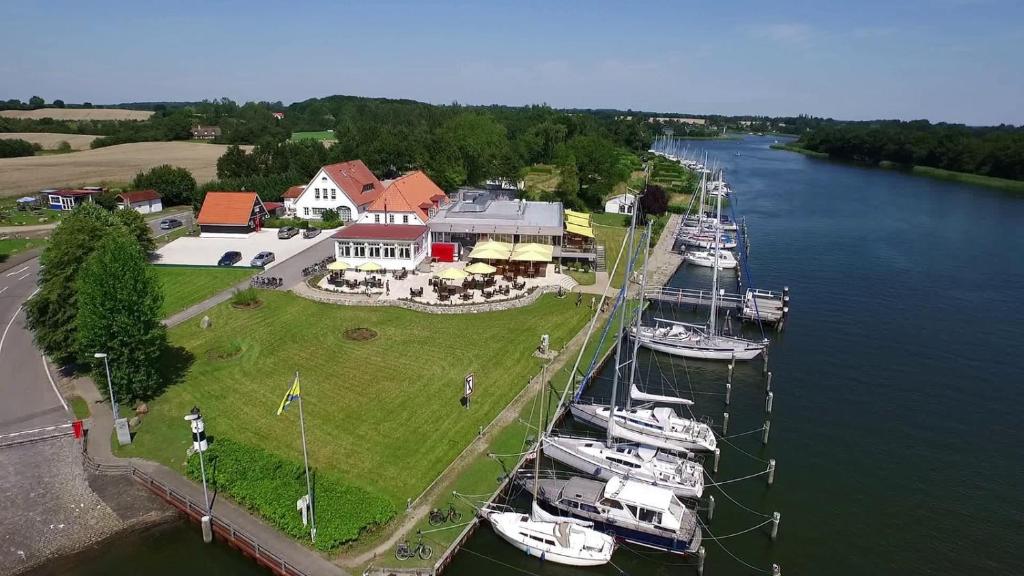 a group of boats are docked in a harbor at Fährhaus Missunde in Brodersby