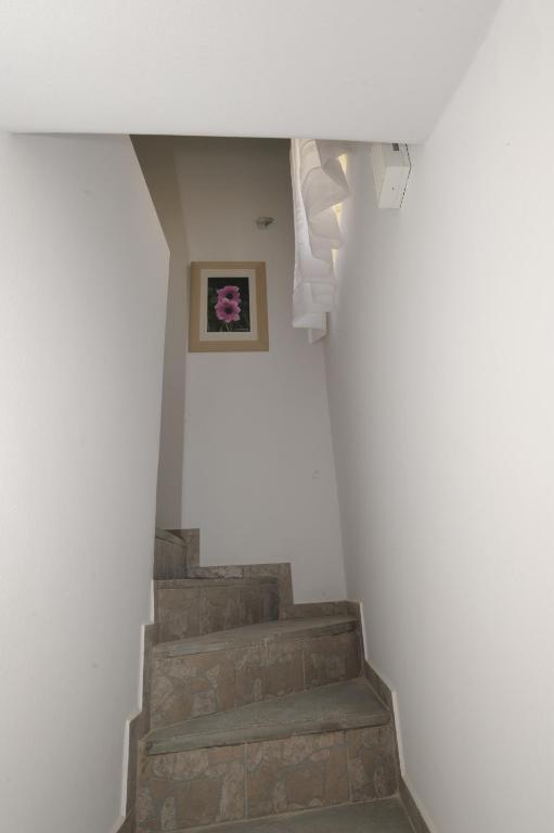 a staircase in a building with a picture on the wall at Thomas Traditional House in Chora in Amorgos