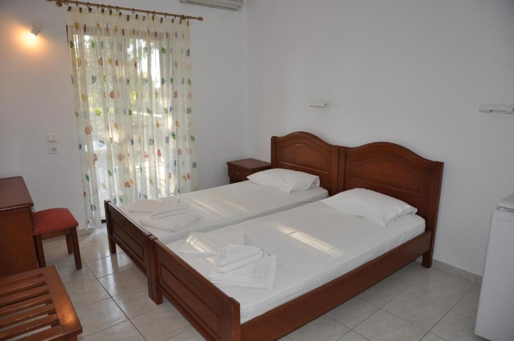 Postel nebo postele na pokoji v ubytování Hotel Dougas