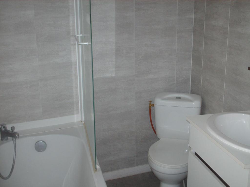 a bathroom with a toilet and a shower and a sink at Meublé de tourisme*** letrilogis in Joinville