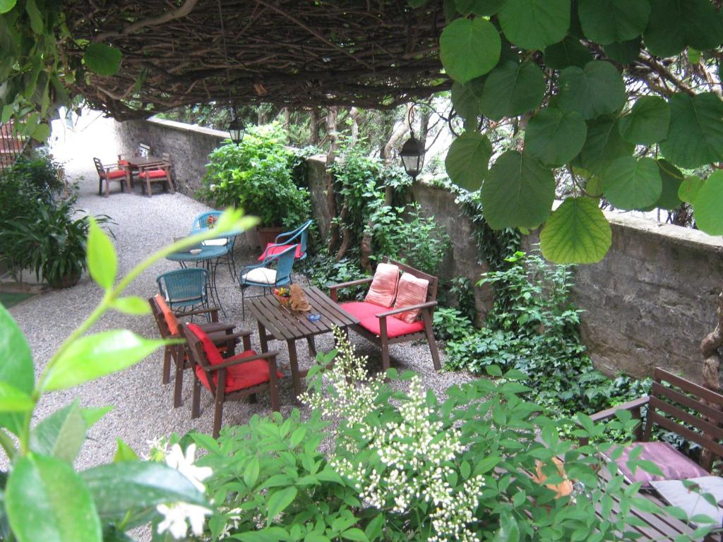 a patio with chairs and a table with at Albergo Sangalli in Boario Terme