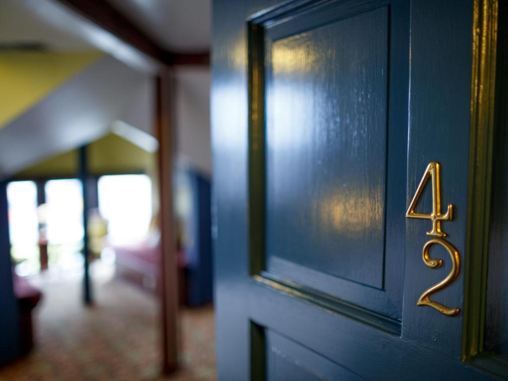 a close up of a door with the number four on it at The Inn at 2nd & C in Eureka
