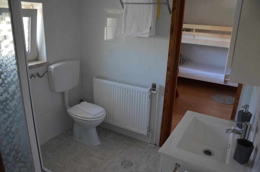 a small bathroom with a toilet and a sink at ABLA Guest House in Carcavelos