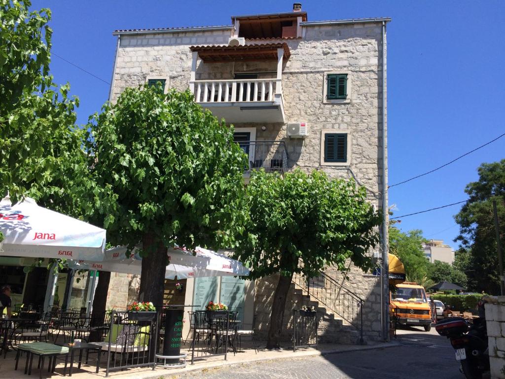 a building with tables and chairs on a street at Morus Alba in Split