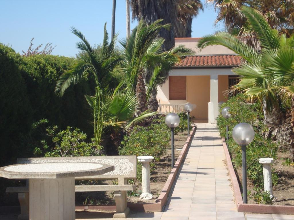 a bench and a table in front of a house at Villa degli Angeli in Santa Maria Del Focallo