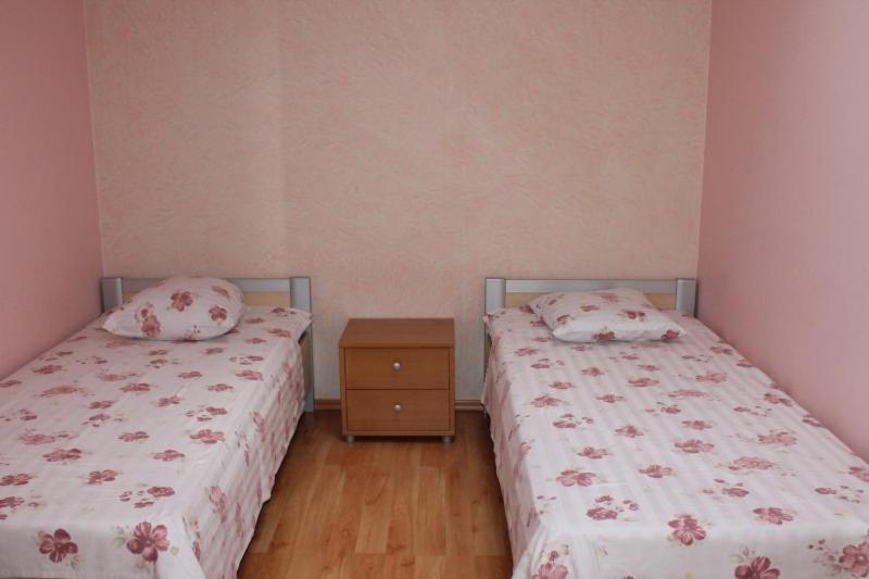 two beds sitting next to each other in a bedroom at Europe Guesthouse in Narva