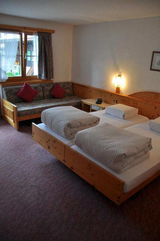 Łóżko lub łóżka w pokoju w obiekcie Hotel Soliva