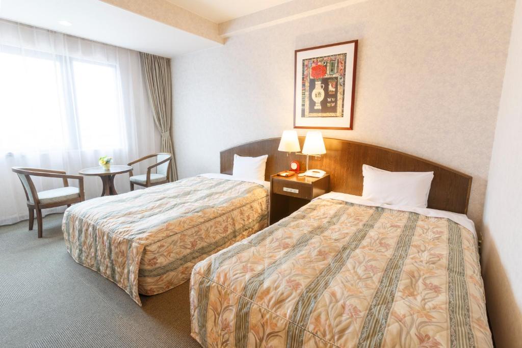 Postel nebo postele na pokoji v ubytování Hotel Amabile Maizuru