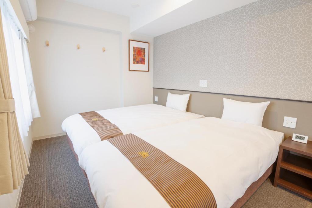 Postel nebo postele na pokoji v ubytování Hotel Amabile Maizuru