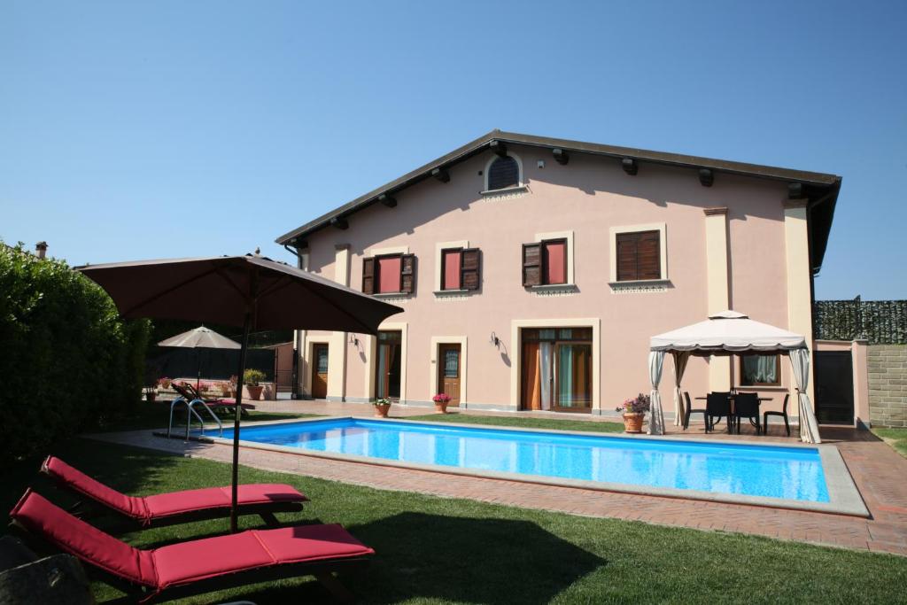 a villa with a swimming pool and a house at Villa Gilda in Bracciano