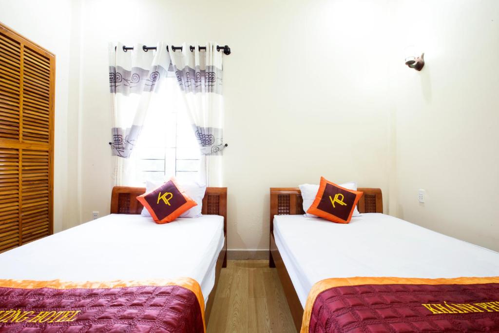 A bed or beds in a room at Khanh Phuong Hotel