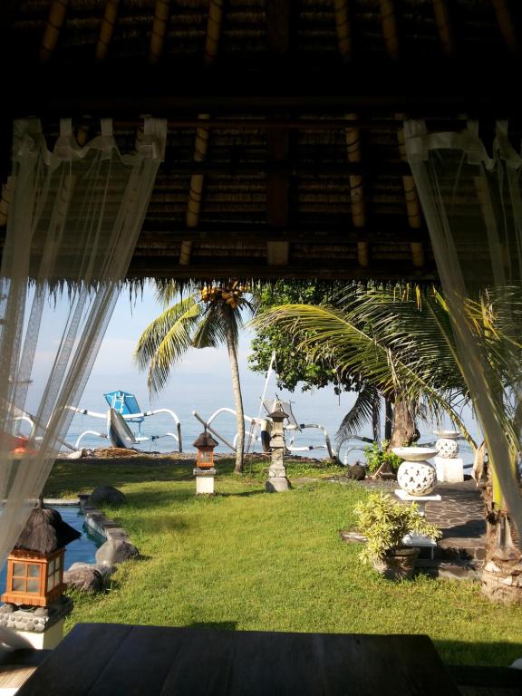 a view of a resort with the ocean in the background at Abalone Resort in Candidasa