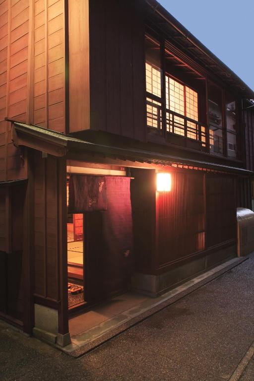 a building with an open door with a light in it at Machiya Kanazawa Kikunoya in Kanazawa