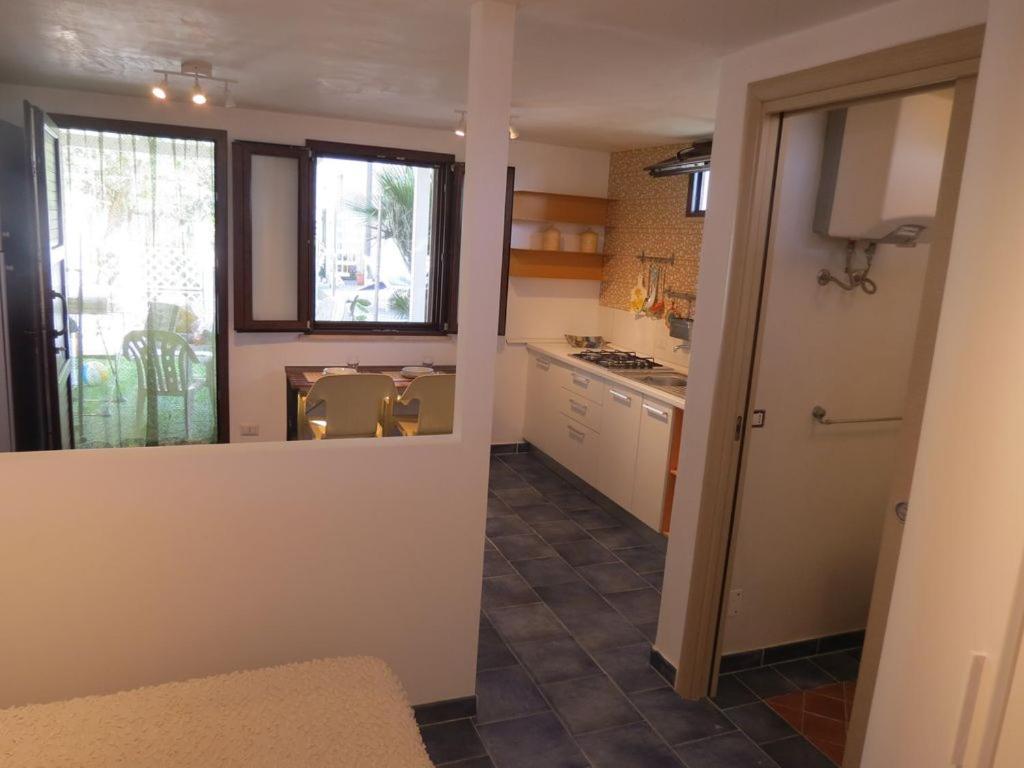a kitchen with a sink and a window and a counter at Casetta Costa Turchina in Pollina