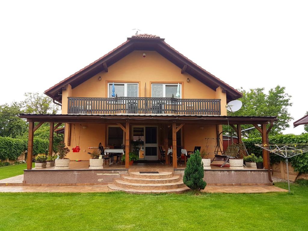 a house with a balcony on top of it at Penzion Termál in Podhájska