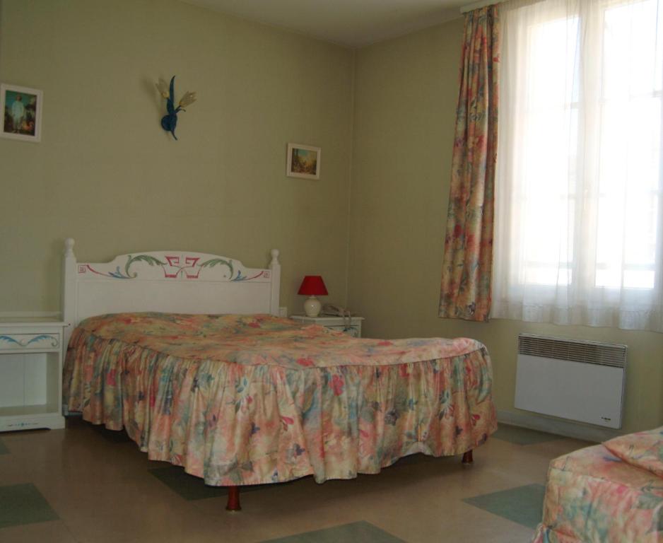Postel nebo postele na pokoji v ubytování Hôtel Bertrand