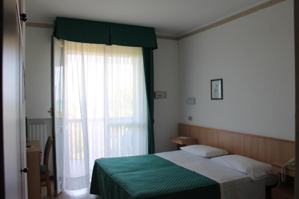 Postel nebo postele na pokoji v ubytování Hotel Fabiola