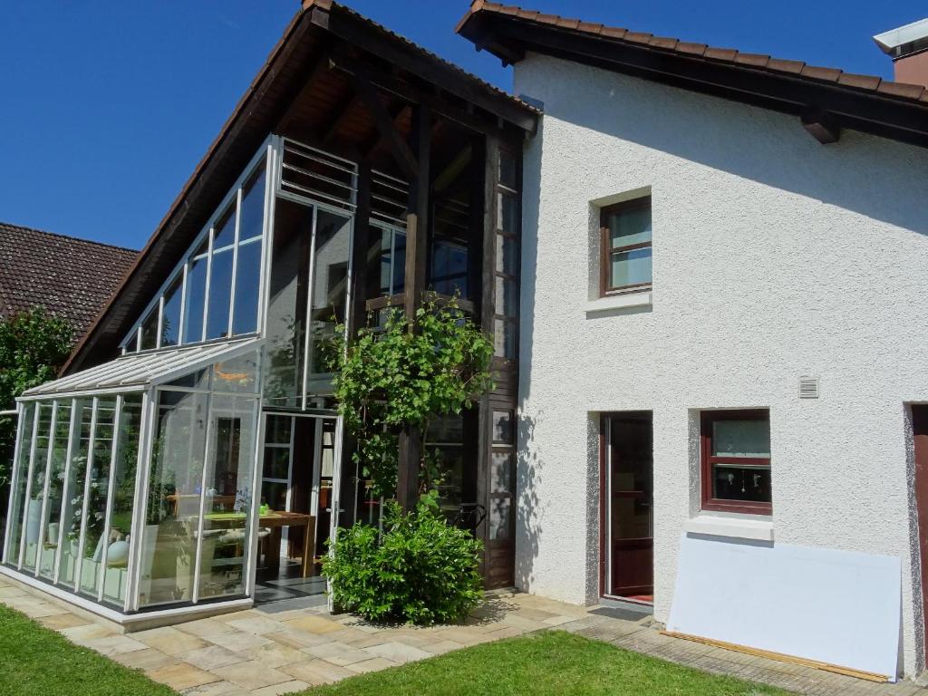 a white house with large glass windows at Wohlfühlhaus Immenstaad in Immenstaad am Bodensee