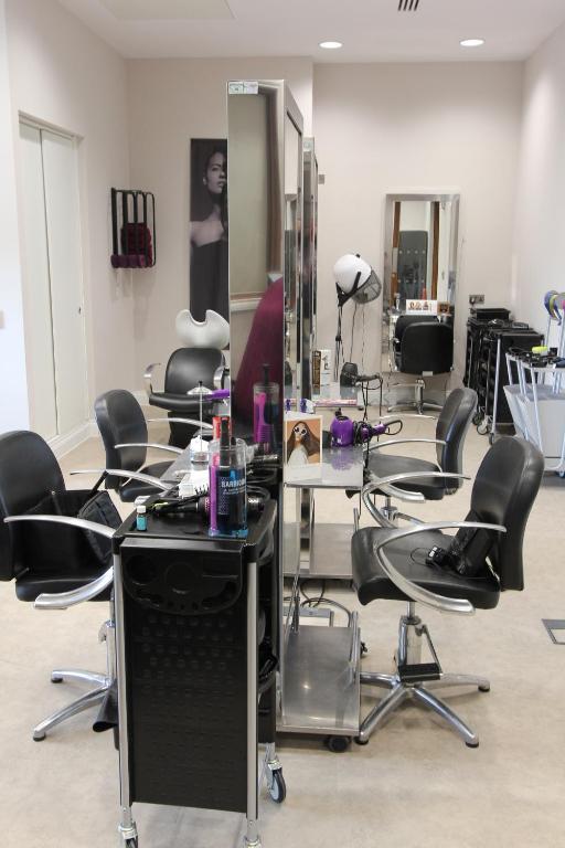 a salon with a lot of chairs and a mirror at Yarrow Hotel in Broadstairs
