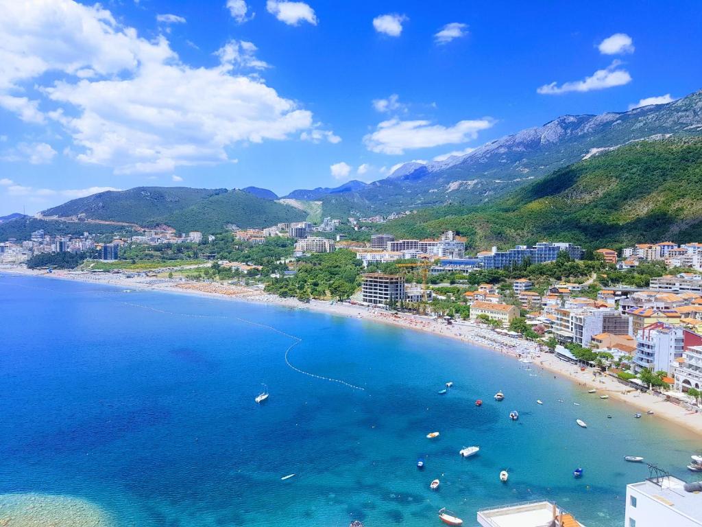 a view of a beach with boats in the water at Apartmani Svetionik in Budva