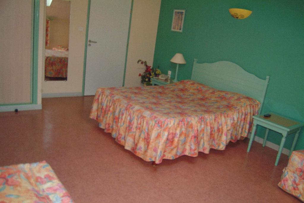 Postel nebo postele na pokoji v ubytování Hôtel Bertrand