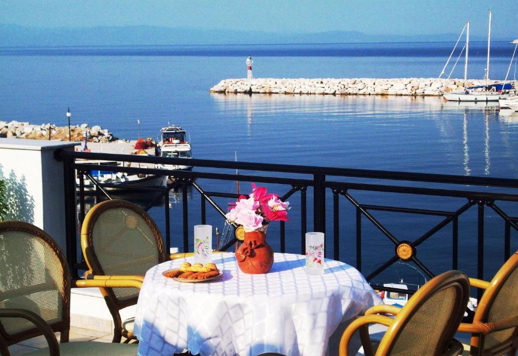 a table with a vase of flowers on a balcony at Anna Maria - Vanessa Apartments in Neo Klima
