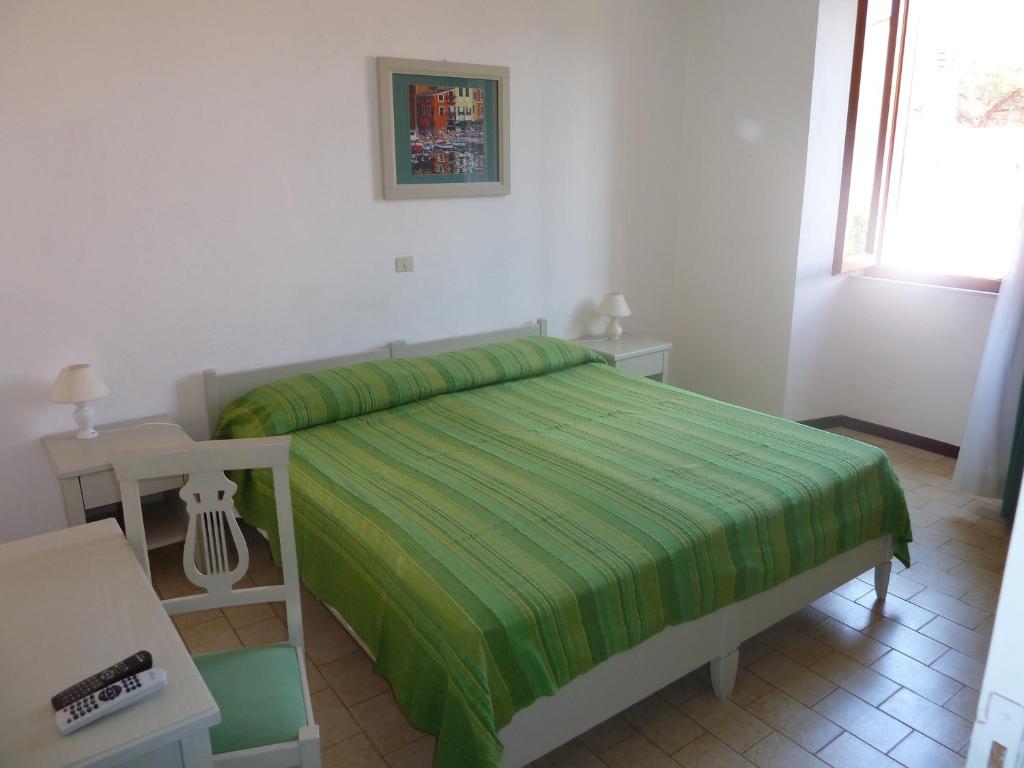 Postel nebo postele na pokoji v ubytování Albergo Dei 10 Colori