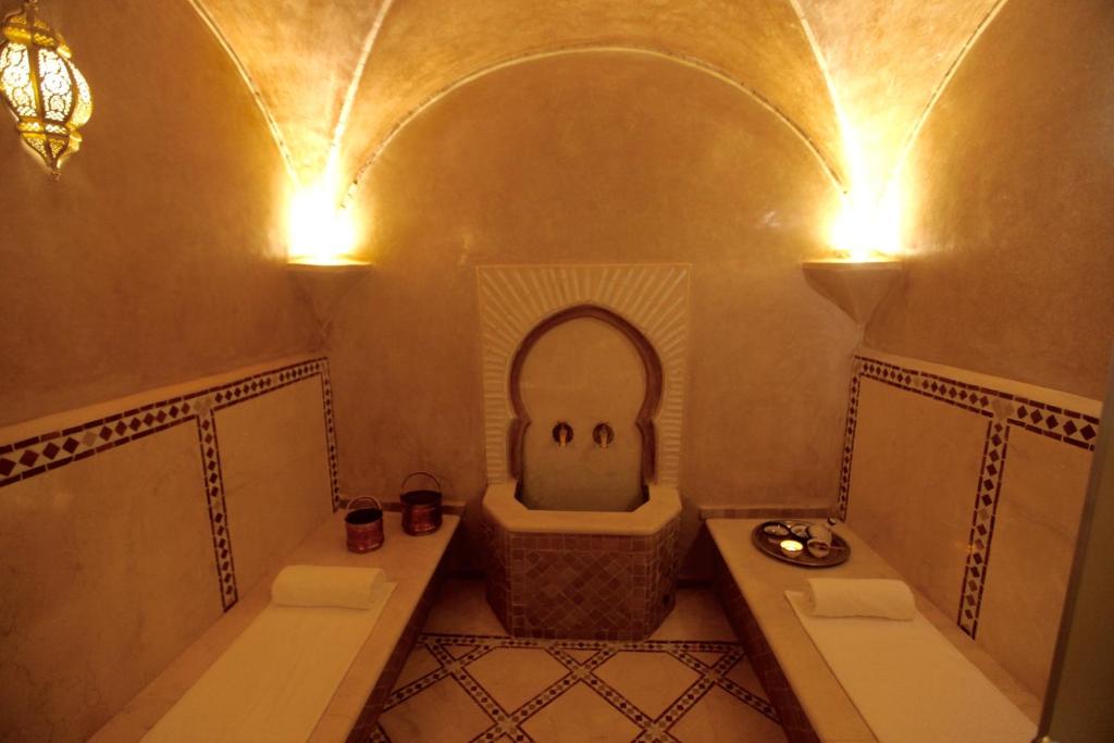 a bathroom with a tub and a toilet and a sink at Riad Dar Haven in Tamraght Ou Fella