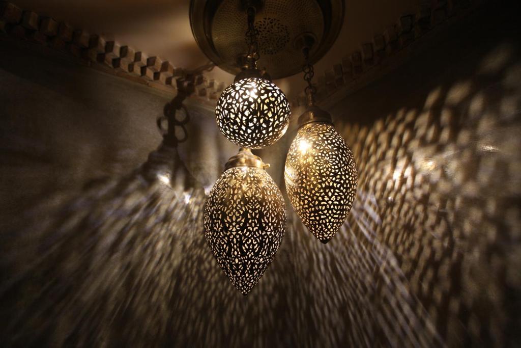 twoadedadedadedadedadedaded lights hanging from a ceiling at Riad Dar Haven in Tamraght Ou Fella