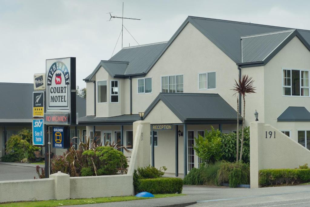 a large white building with a sign in front of it at Fitzherbert Court Motel in Hokitika