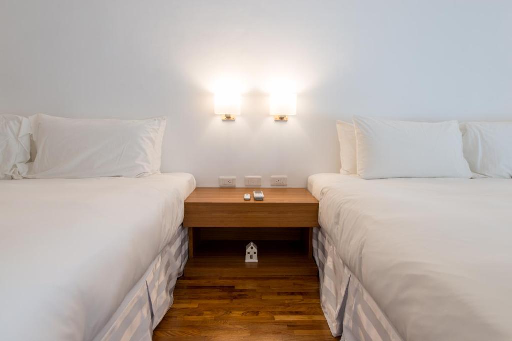Postel nebo postele na pokoji v ubytování 後面有灣Hooope Inn