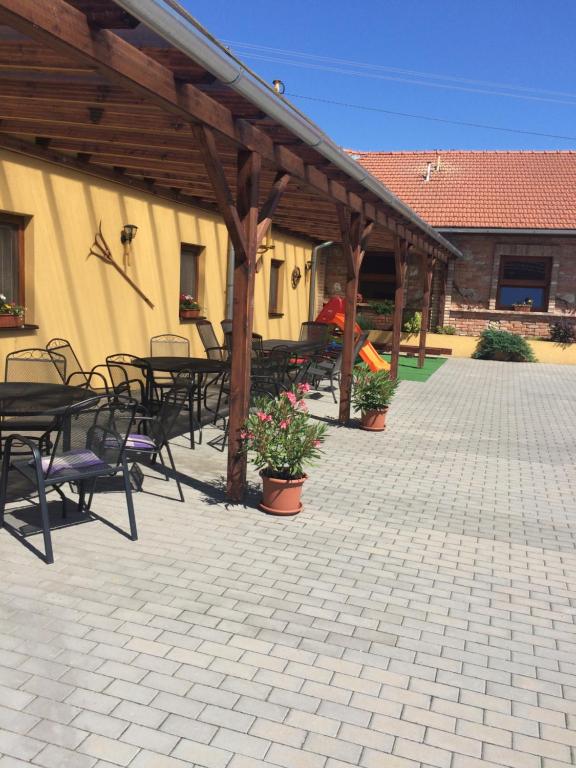 a patio with tables and chairs and a building at Sedlecký Dvůr in Sedlec