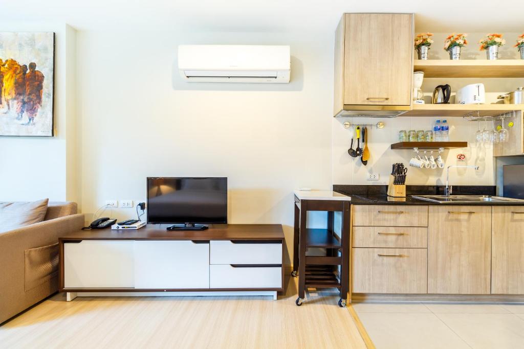 a kitchen with a desk and a counter top at Apartments at The Bliss Condo by Lofty in Patong Beach