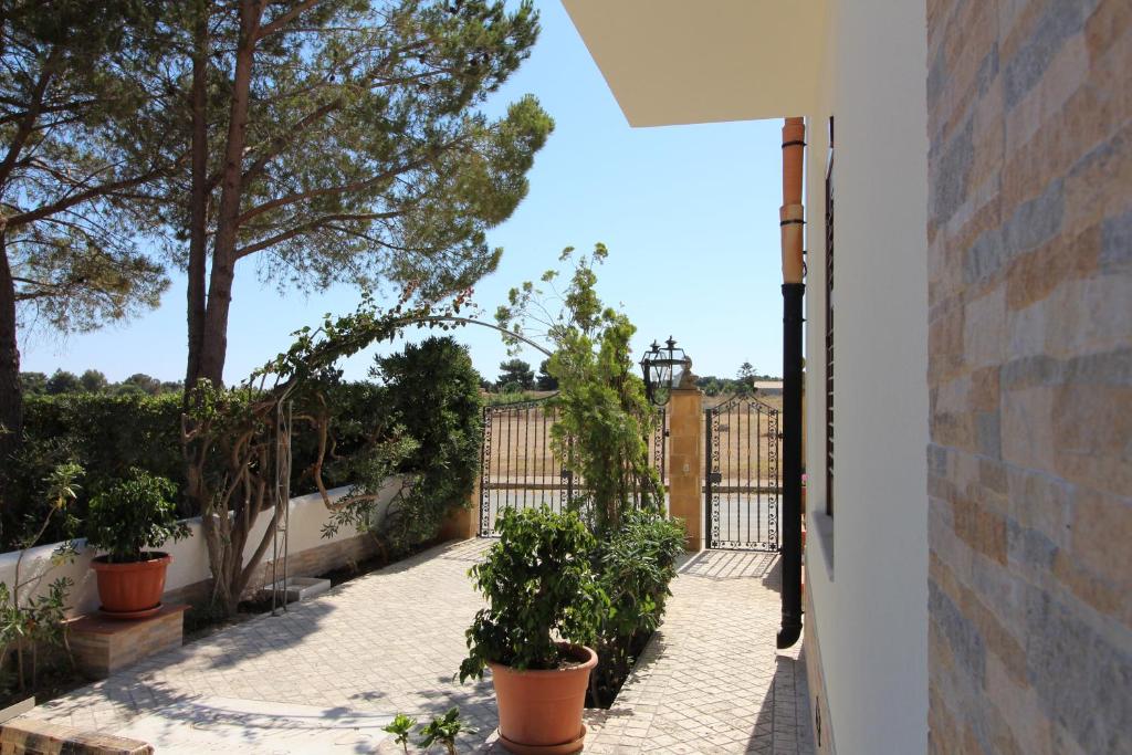 a balcony with potted plants and a fence at B&B Villa Bea in San Vito lo Capo