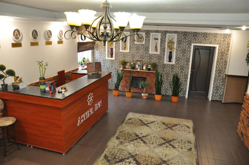 a lobby of a salon with a reception desk at Astina Hotel in Astana