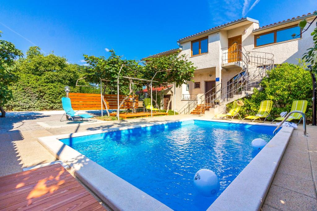 a swimming pool in front of a house at Apartment Ruby in Pula