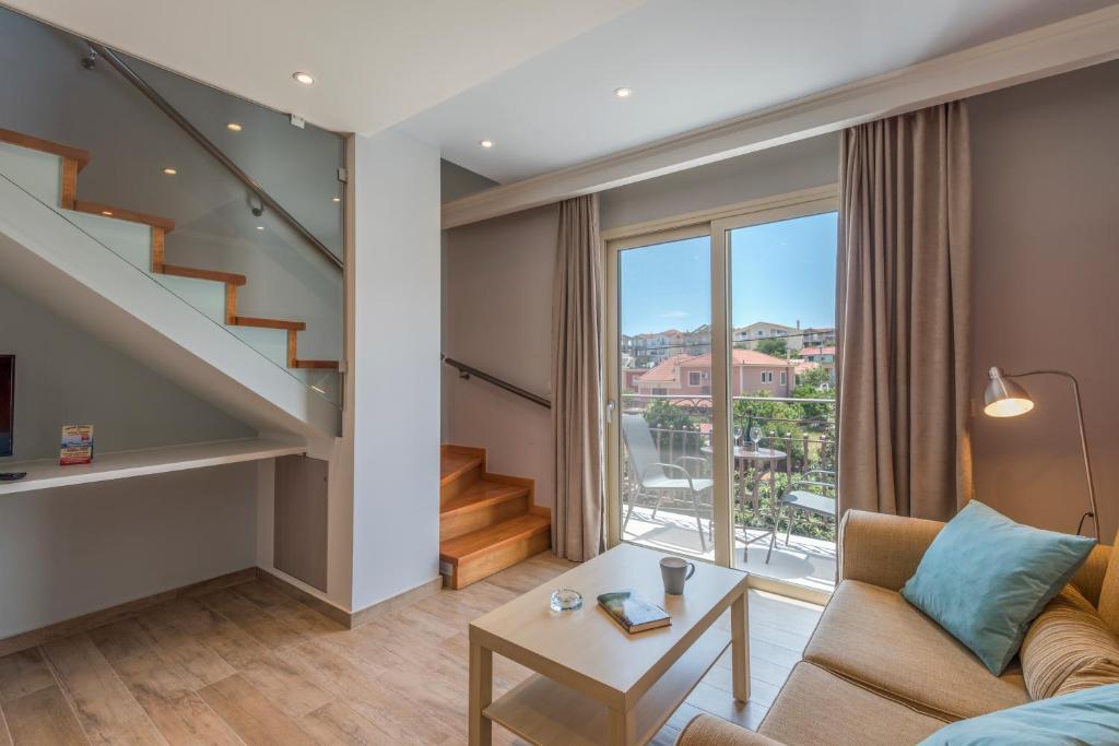 a living room with a staircase and a couch at Pansion Ermioni in Skala