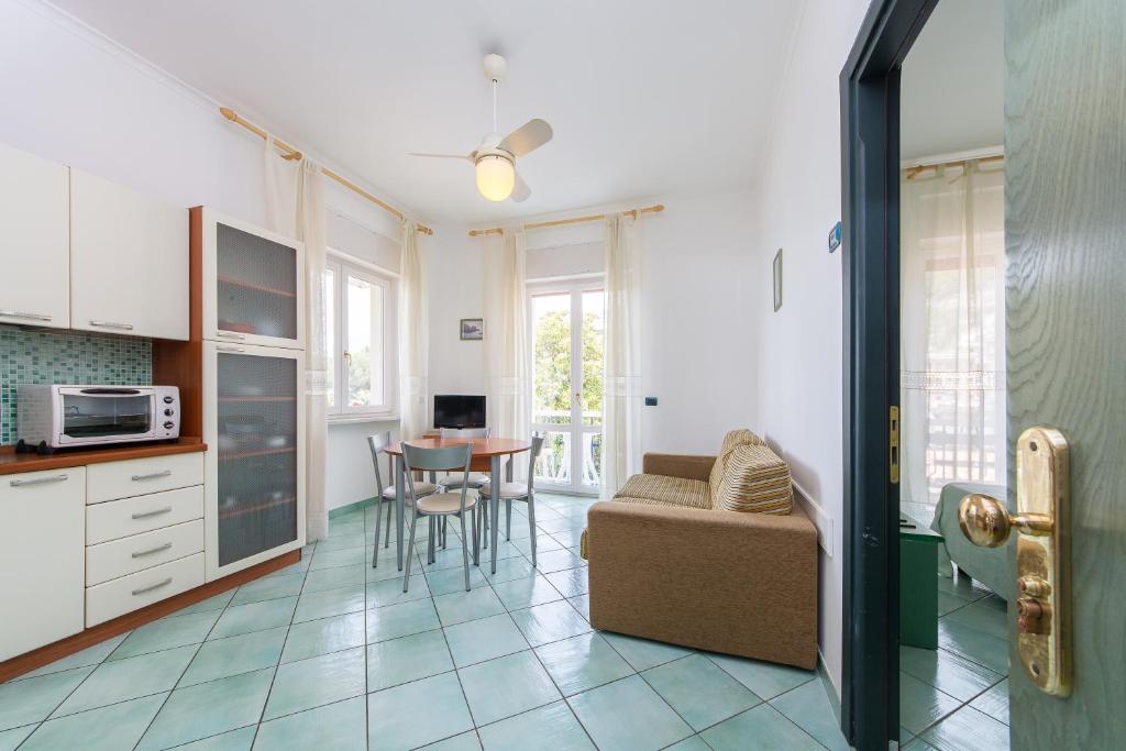 a kitchen and living room with a couch and a table at La Residenza Aparthotel in Maiori