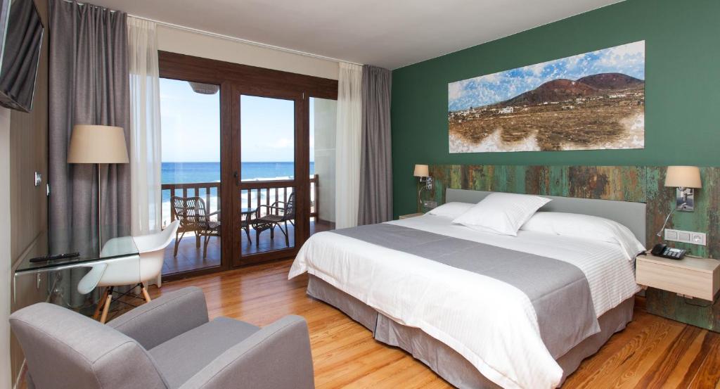 a bedroom with a bed and a view of the ocean at Hotel el Mirador de Fuerteventura in Puerto del Rosario