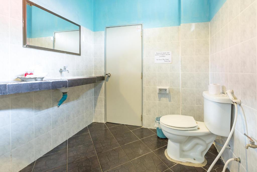 a bathroom with a toilet and a sink and a mirror at Bottle Beach 1 Resort in Bottle Beach