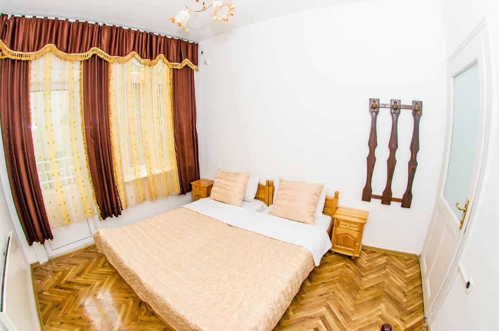 A bed or beds in a room at Central GuestHouse Five Corners