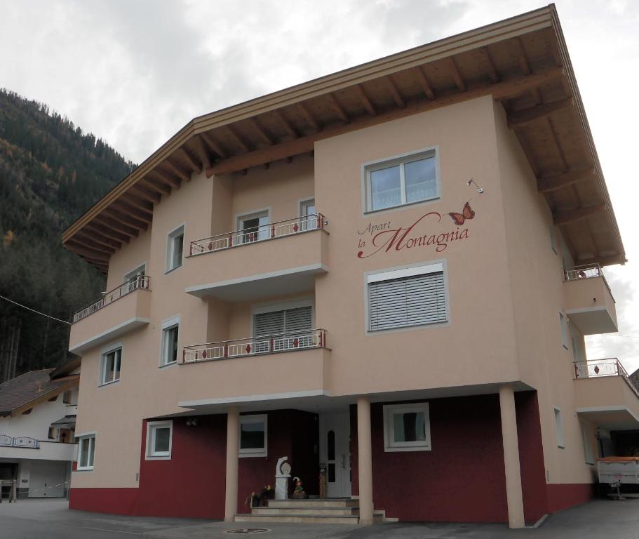 a building with a sign on the side of it at Apart la Montagnia in Kappl