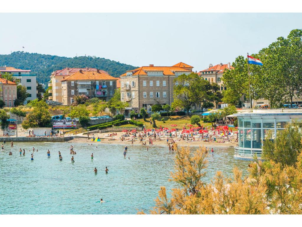 a group of people in the water at a beach at IDRO Studio Apartments directly at the beach in Split
