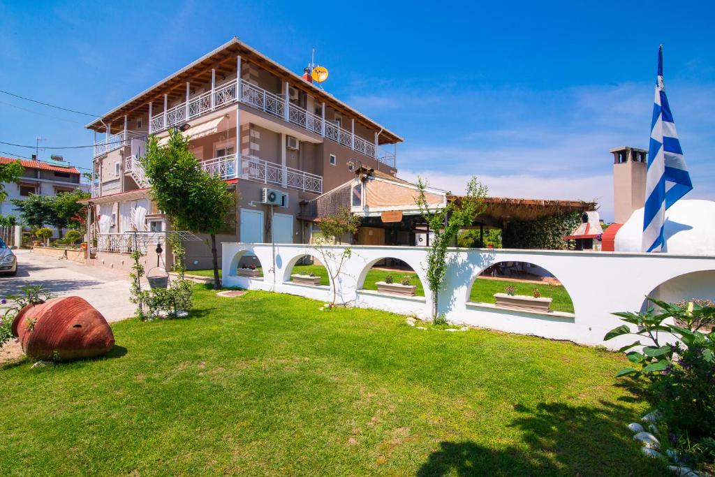a white bridge in a yard with a building at Villa Ioanna in Potos