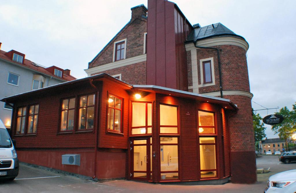 a building with a large window on a street at Go to sleep Arvika in Arvika